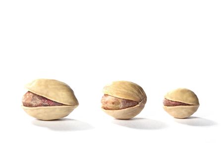 pistachios isolated on white backgroundの写真素材