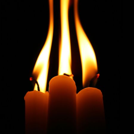 sacred candles in dark on black backgroundの写真素材