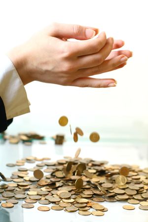 hand make coins rain on white