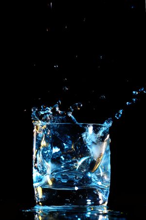 alcohol splash on black backgroundの写真素材