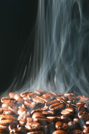 macro coffee beans in aroma smokeの写真素材