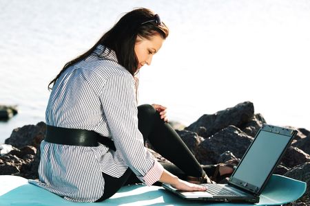 woman with laptop sea backgroundの写真素材