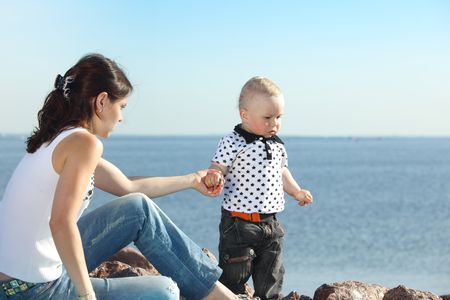 happy mother and son on picnic near seaの写真素材