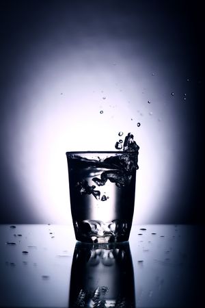alcohol splash on gray backgroundの写真素材