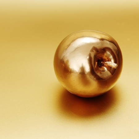 gold apple on gold backgroundの写真素材