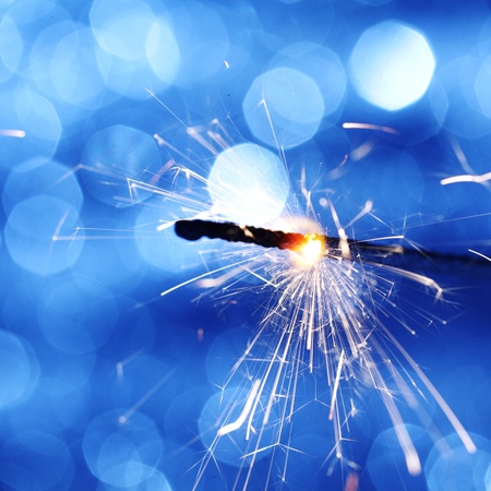 sparkler on blue bokeh background macro close upの写真素材