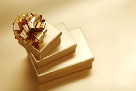 golden christmas gifts on gold background の写真素材