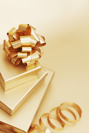 golden christmas gifts on gold background の写真素材