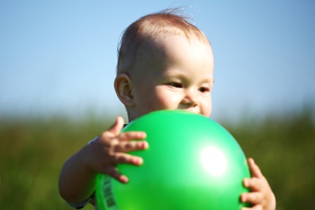 young smile boy play green ballの写真素材