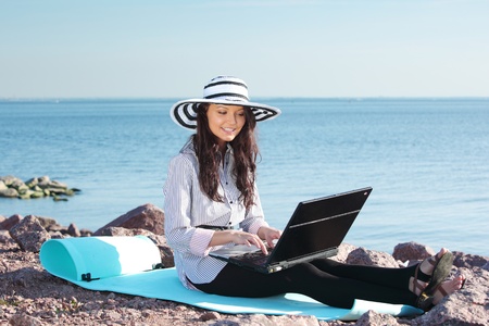 woman with laptop sea backgroundの写真素材