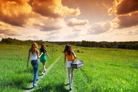 girlfriends on picnic in green grass fieldの写真素材