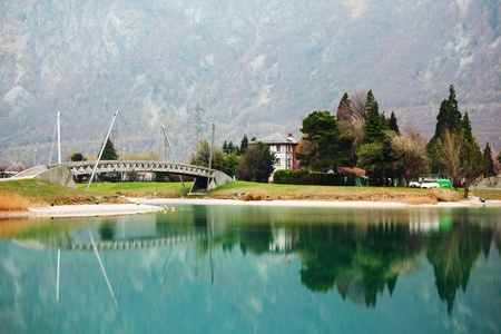 tree reflection in spring mountain lakeの写真素材
