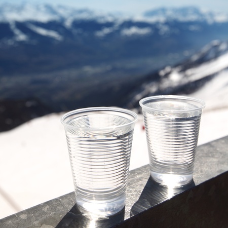 water in cup mountains on backgroundの写真素材