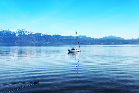 yacht in lake of geneva landscape on sunriseの写真素材