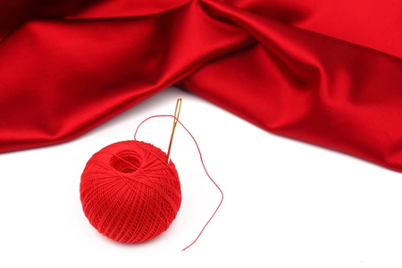 red satin and thread isolated on whiteの写真素材
