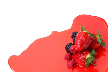 berry mixed pile in syrup isolated on whiteの写真素材