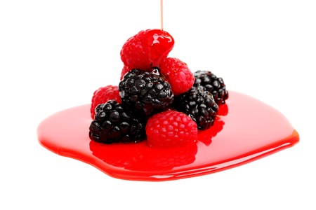 berry mixed pile in syrup isolated on whiteの写真素材