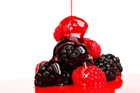 berry mixed pile in syrup isolated on whiteの写真素材