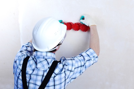 worker puts the wires in the wallの写真素材