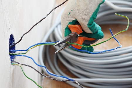 worker puts the wires in the wallの写真素材