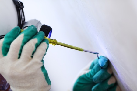 worker puts the wires in the wallの写真素材