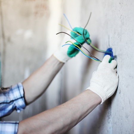 worker puts the wires in the wallの写真素材