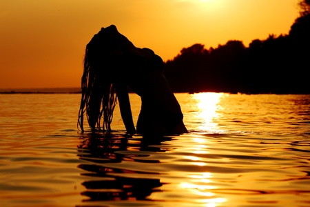 ocean woman in sunrise lightの写真素材