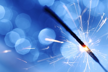 sparkler on blue bokeh background macro close upの写真素材