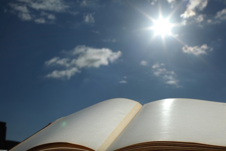  book of wisdom on sun sky backgroundの写真素材