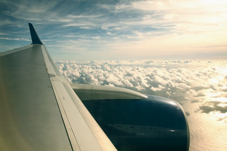 airplane fly in blue sky cloud aroundの写真素材