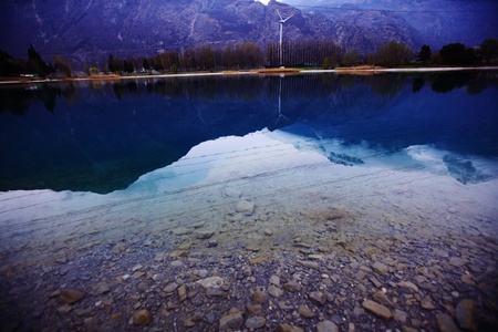 tree reflection in spring mountain lakeの写真素材