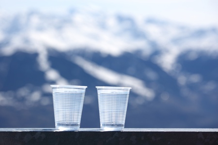 water in cup mountains on backgroundの写真素材