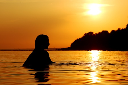 ocean woman in sunrise lightの写真素材