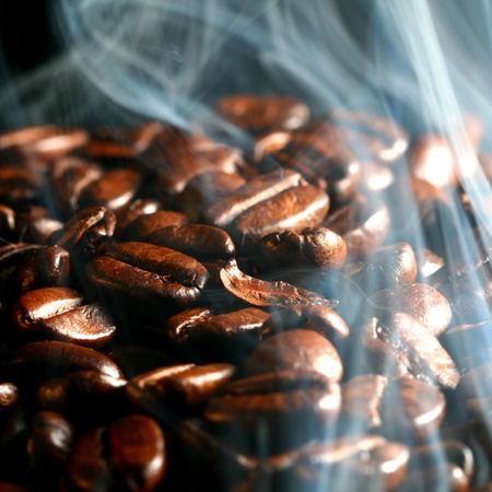 macro coffee beans in aroma smokeの写真素材