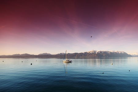 yacht in lake of geneva landscape on sunriseの写真素材
