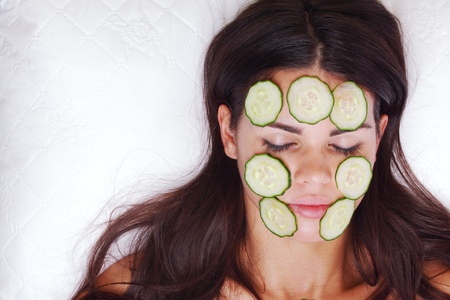cucumbers circles on a girl faceの写真素材
