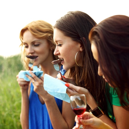 girls drink wine on nature backgroundの写真素材