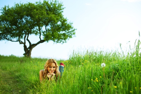 blonde lays under the tree の写真素材