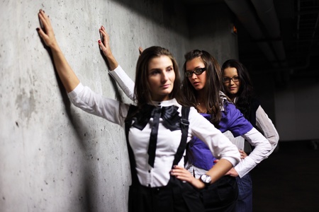 underground girlfriends around stone wallの写真素材