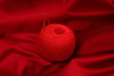 red satin and thread isolated on whiteの写真素材