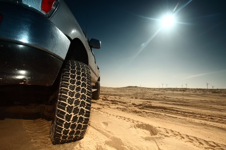 truck in desert sand and blue skyの写真素材