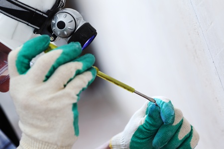 worker puts the wires in the wallの写真素材