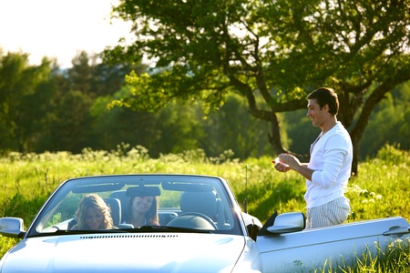 friends group in cabriolet go travelの写真素材