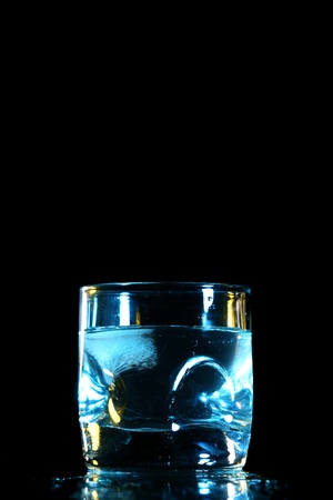 alcohol splash on black backgroundの写真素材