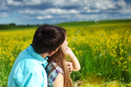 lovers hug on yellow flower fieldの写真素材