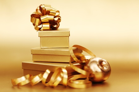 golden christmas gifts on gold background の写真素材