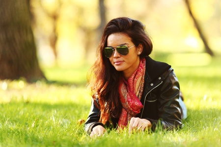 woman lay on green grass in parkの写真素材