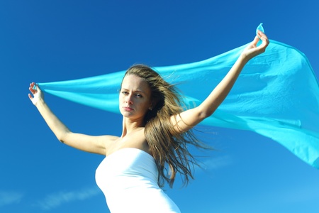 woman fly in the blue sky by fabricの写真素材