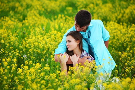 lovers hug on yellow flower fieldの写真素材