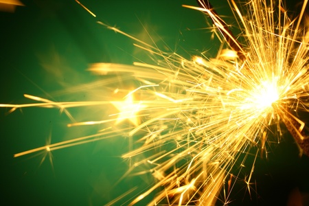 christmas sparkler on green backgroundの写真素材